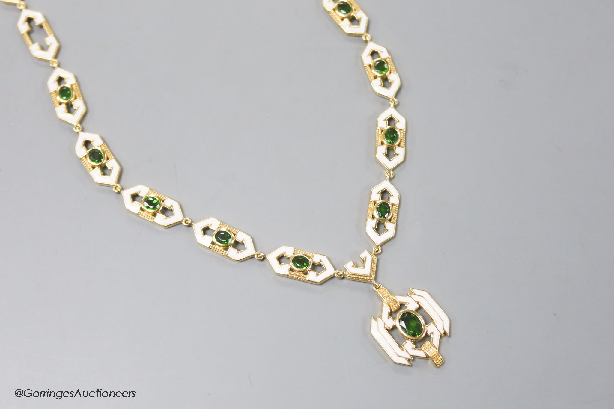 A modern stylish 925 gilt white metal, green paste and enamel set necklace, 50cm